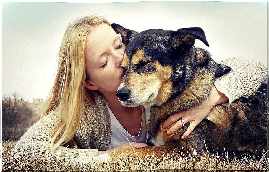 Woman giving her dog a kiss